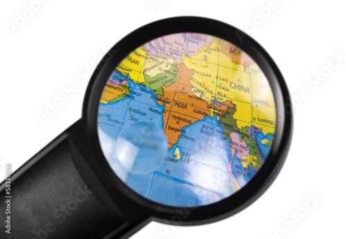 Photography India on globe viewed through a magnifying glass