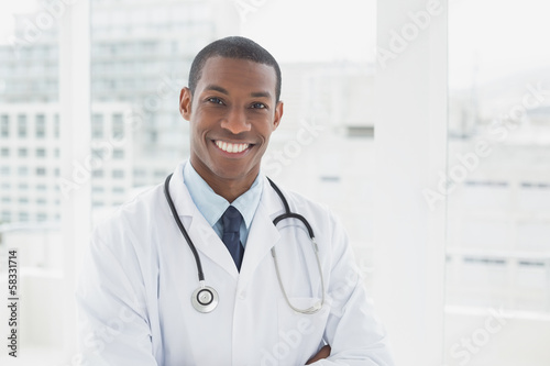 Confident smiling male doctor in a medical office
