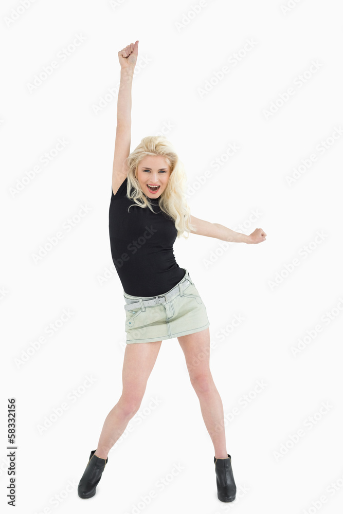 Full length of a cheerful beautiful casual blond Full length of a cheerful beautiful casual blond