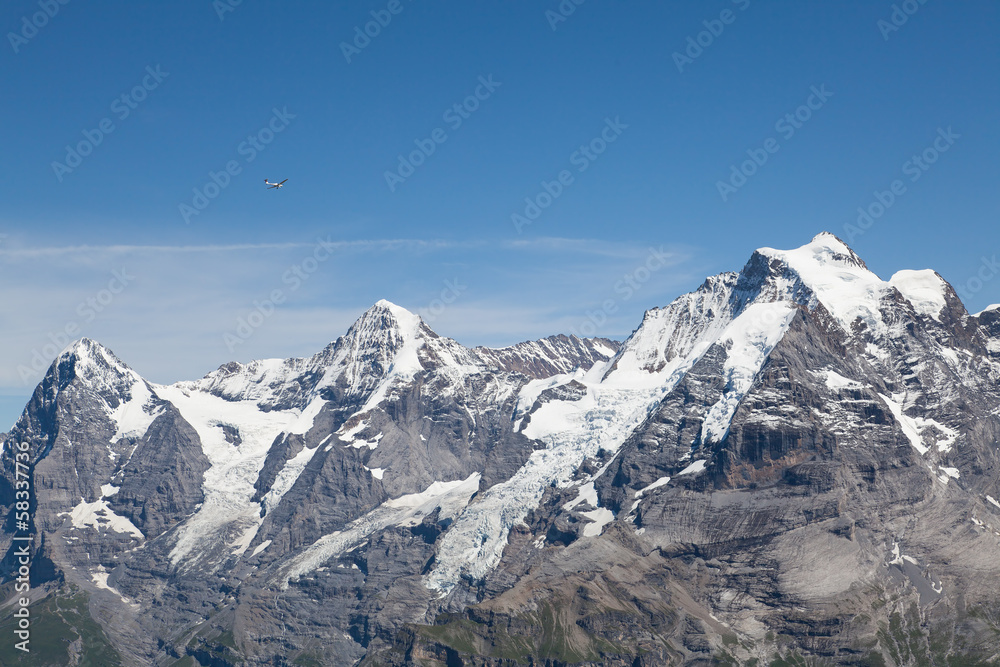 Small plane & mountains - view from Mt. Schilthorn Small plane & mountains - view from Mt. Schilthorn