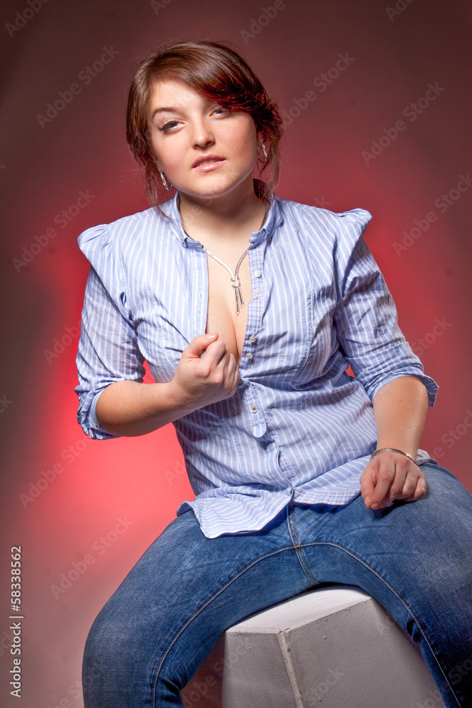 sexy girl sitting on chair and opening button on shirt Stock Photo | Adobe  Stock