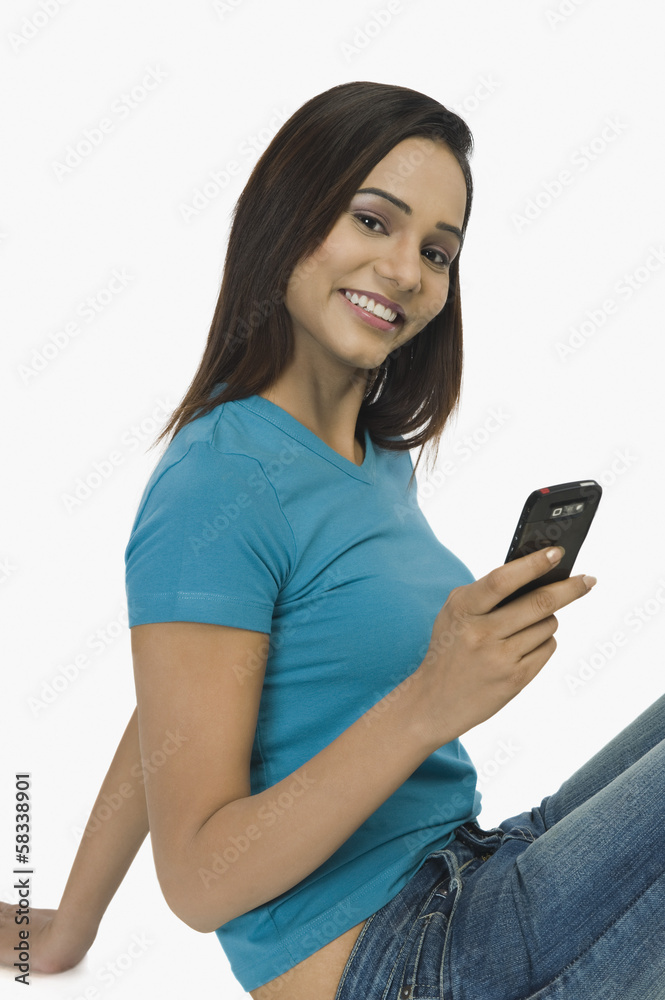 Woman text messaging on a mobile phone Woman text messaging on a mobile phone