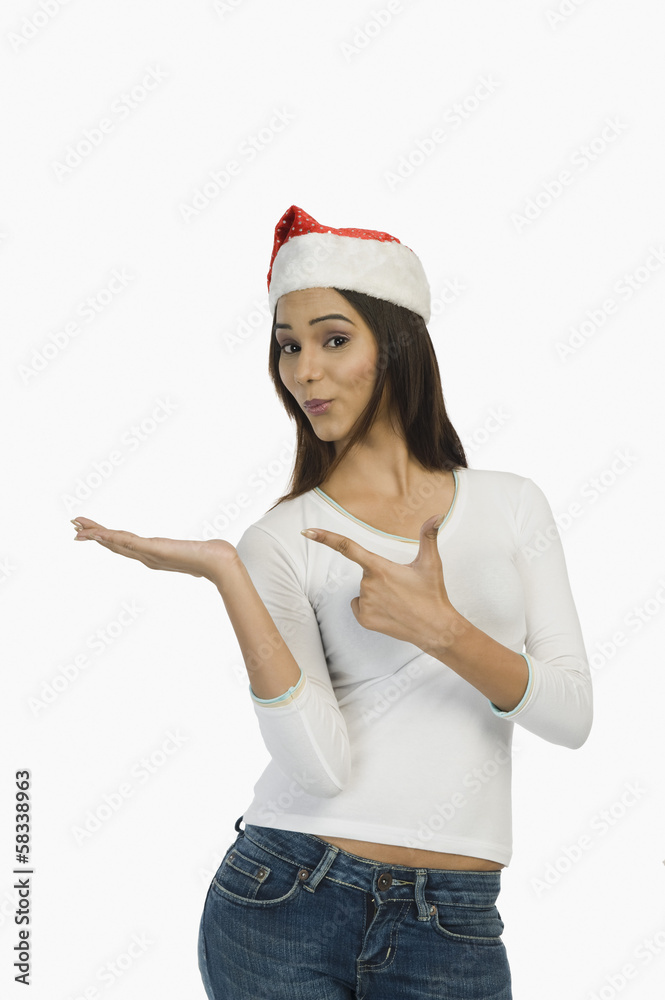 Woman wearing a Santa hat and gesturing