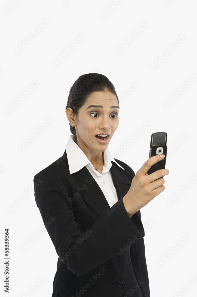 Businesswoman looking at a mobile phone Businesswoman looking at a mobile phone