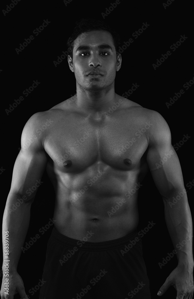 Portrait of a muscular man showing his abs Portrait of a muscular man showing his abs