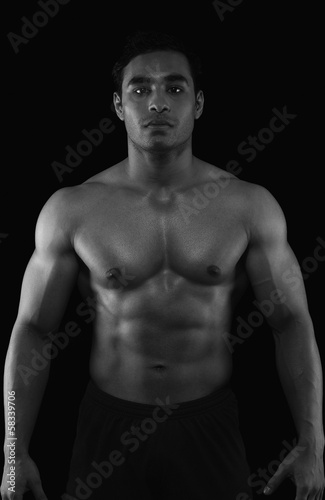 Portrait of a muscular man showing his abs
