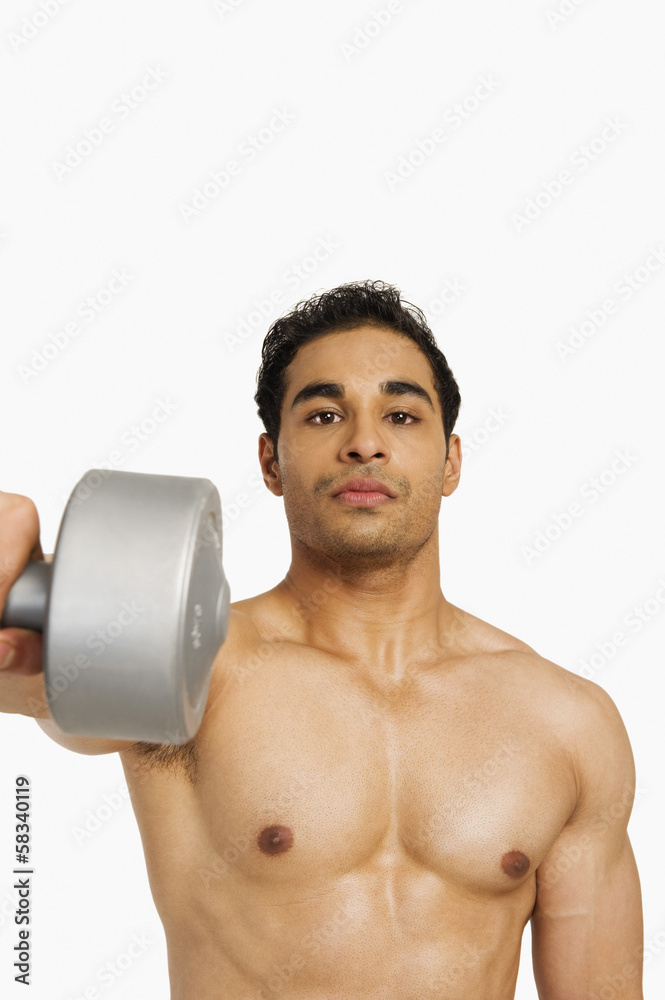 Portrait of a man exercising with a dumbbell Portrait of a man exercising with a dumbbell