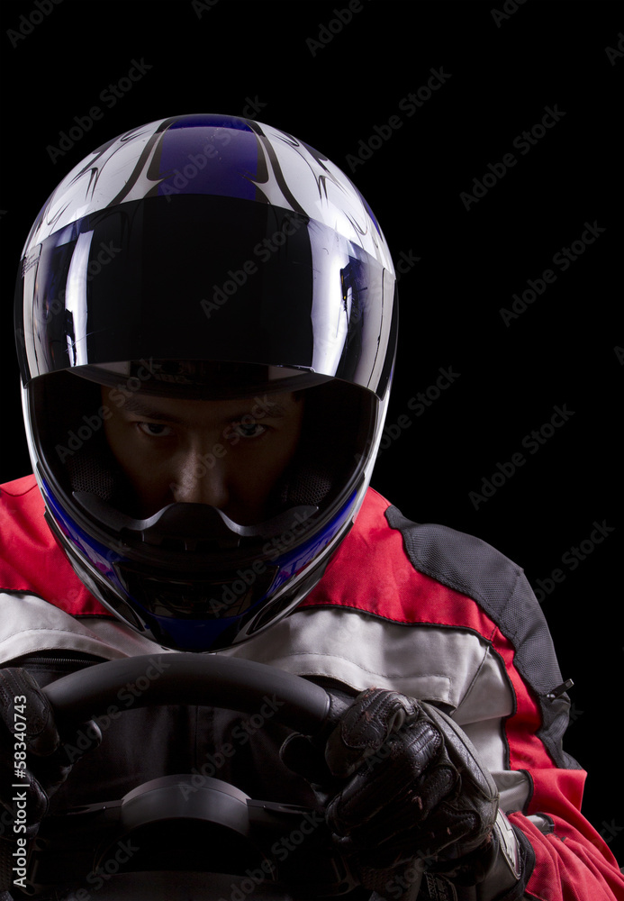 racerwearing red racing suit and blue helmet on a steering wheel Stock ...