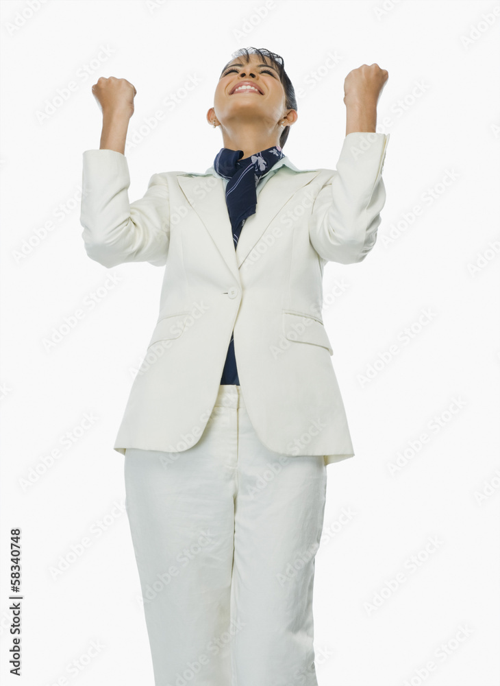 Businesswoman clenching fists in excitement Businesswoman clenching fists in excitement