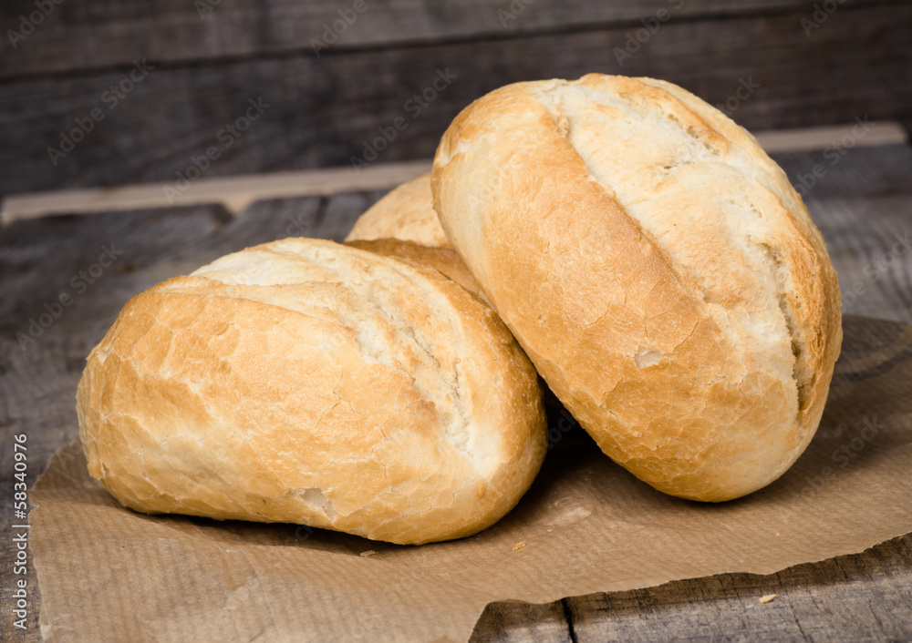 Wheat bread roll on a cutting board Wheat bread roll on a cutting board