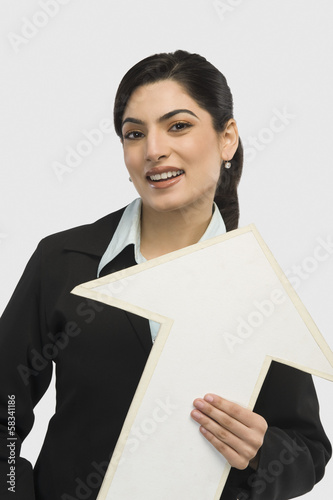 Businesswoman holding an upward arrow sign