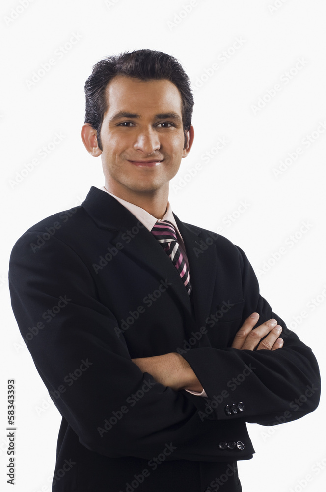 Portrait of a businessman standing with his arms crossed and smiling Portrait of a businessman standing with his arms crossed and smiling