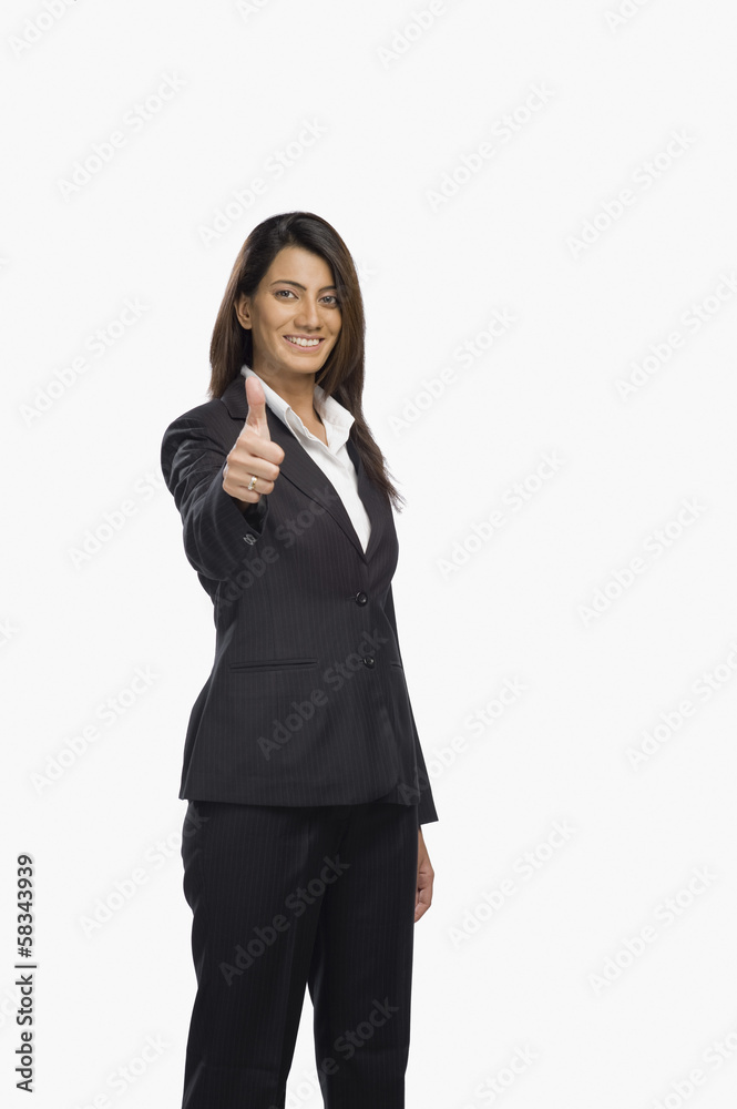 Portrait of a businesswoman gesturing thumbs up sign Portrait of a businesswoman gesturing thumbs up sign