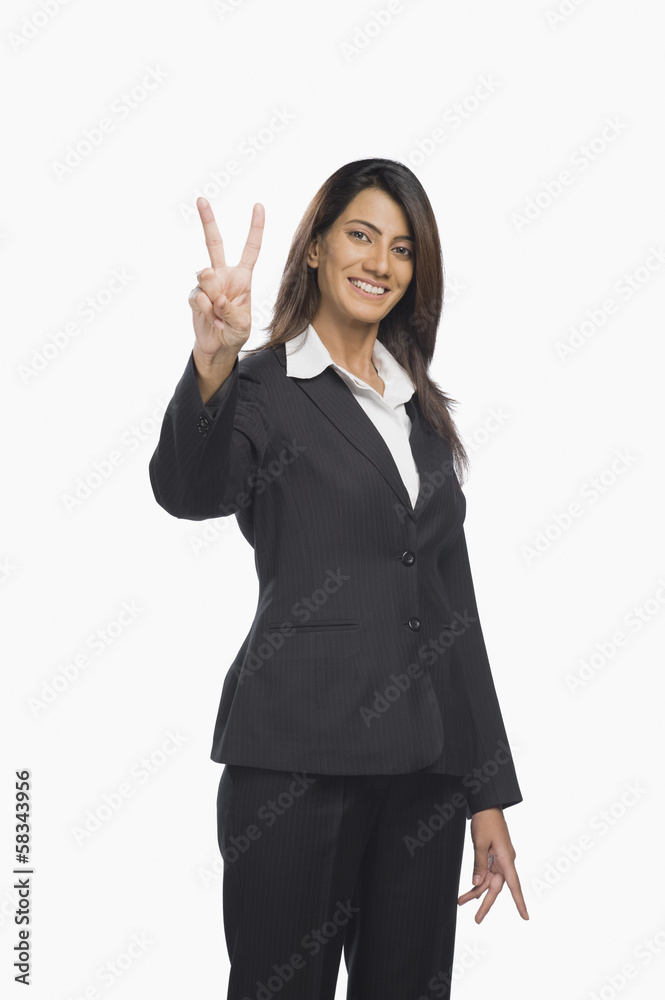 Portrait of a businesswoman gesturing victory sign Portrait of a businesswoman gesturing victory sign