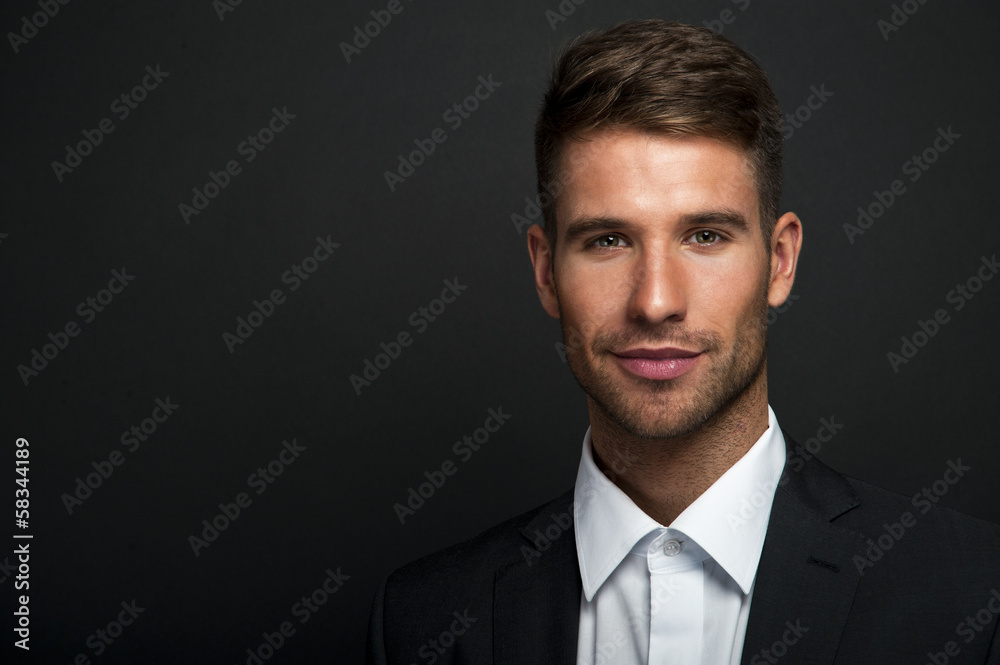 Businessman standing on dark gradient background Businessman standing on dark gradient background