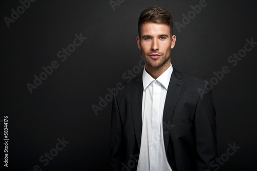 Businessman standing on dark gradient background