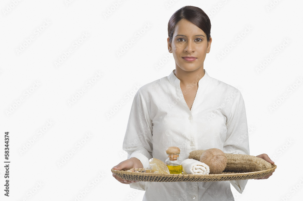 Woman holding a tray of products for aromatherapy Woman holding a tray of products for aromatherapy