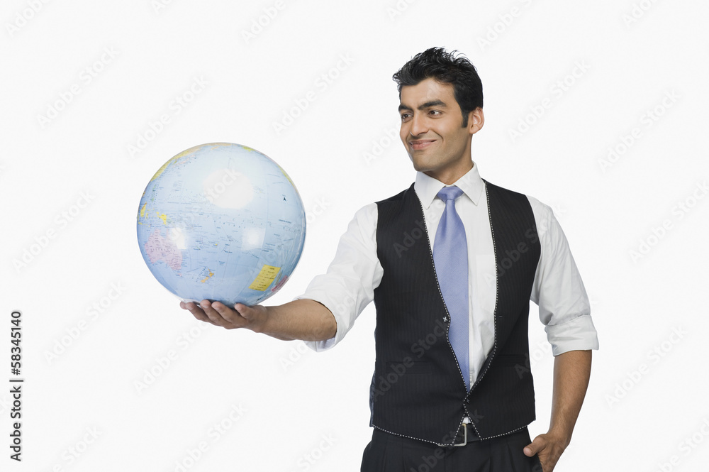 Businessman holding a globe and smiling Businessman holding a globe and smiling