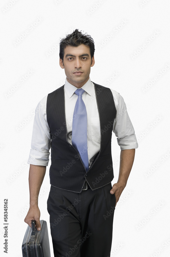 Fototapeta premium Portrait of a businessman holding a briefcase