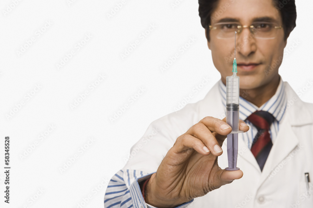 Close-up of a doctor holding a syringe Close-up of a doctor holding a syringe