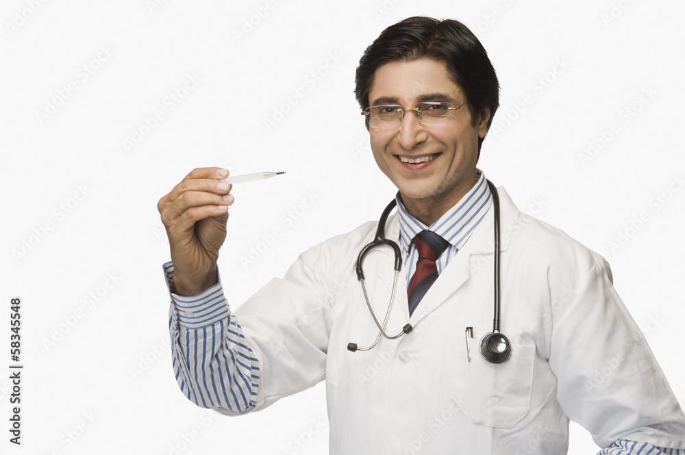 Portrait of a doctor holding a thermometer and smiling Portrait of a doctor holding a thermometer and smiling