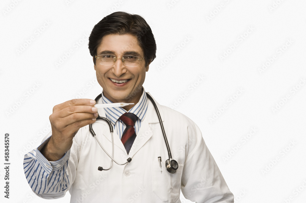 Portrait of a doctor holding a thermometer and smiling Portrait of a doctor holding a thermometer and smiling