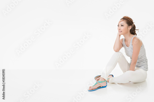 Attractive asian woman sit on ground