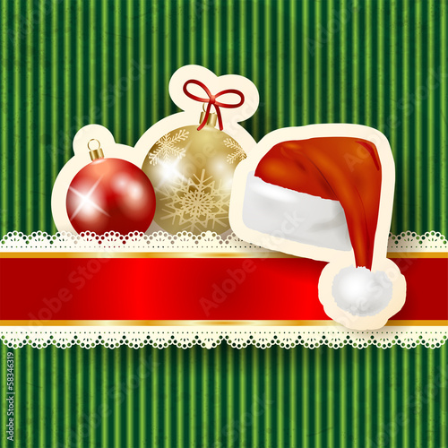 Christmas baubles and hat on cardboard background