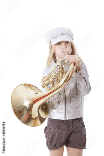 young girl with cap playing french horn