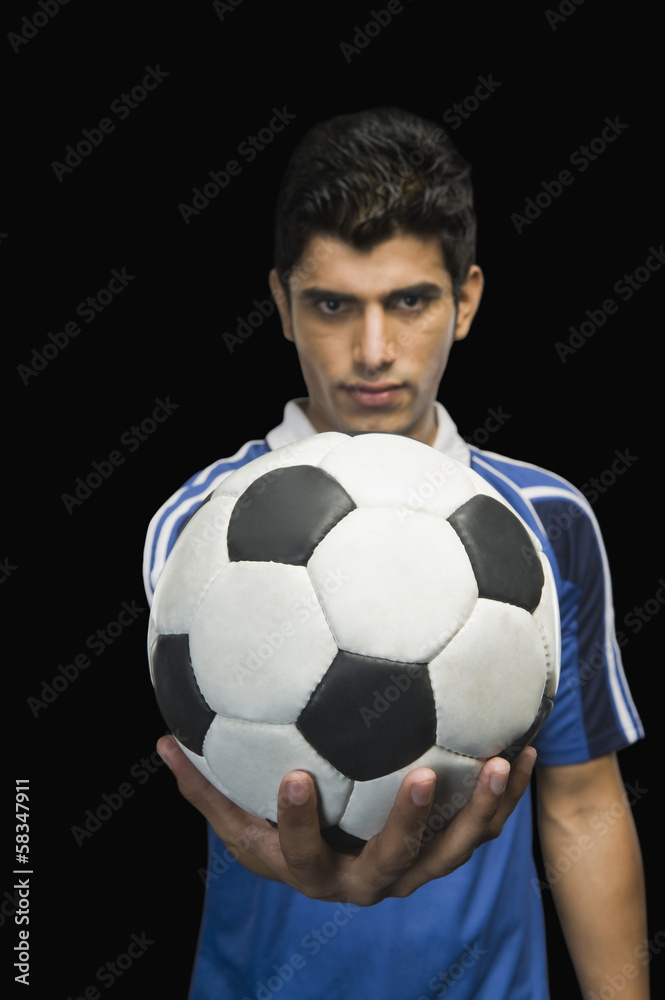 Soccer player showing a soccer ball Soccer player showing a soccer ball