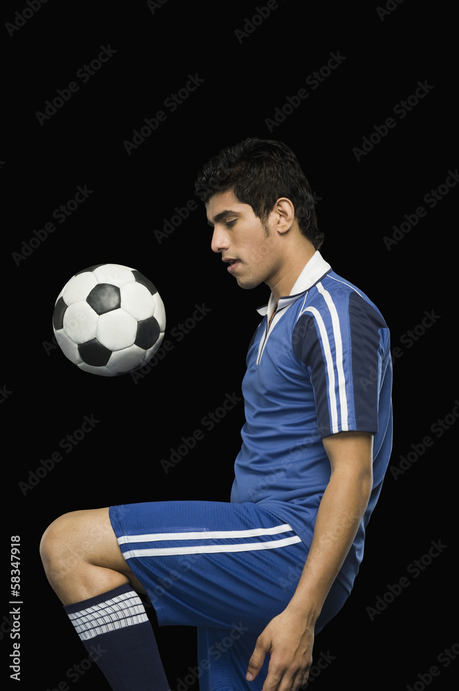 Soccer player practicing with a soccer ball Soccer player practicing with a soccer ball