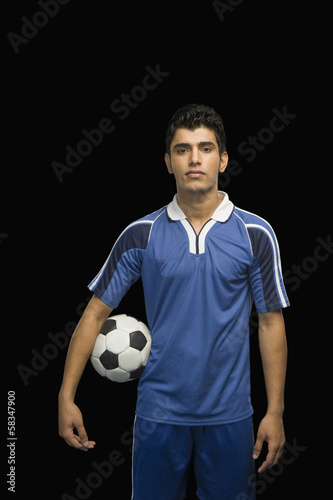 Soccer player holding a soccer ball