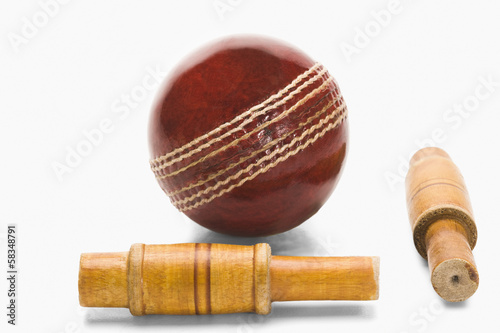 Close-up of a cricket ball and bails