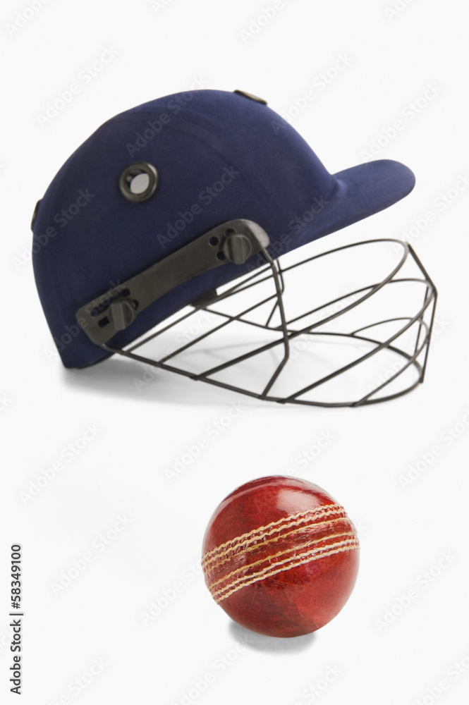 Naklejka premium Close-up of a cricket ball and a helmet