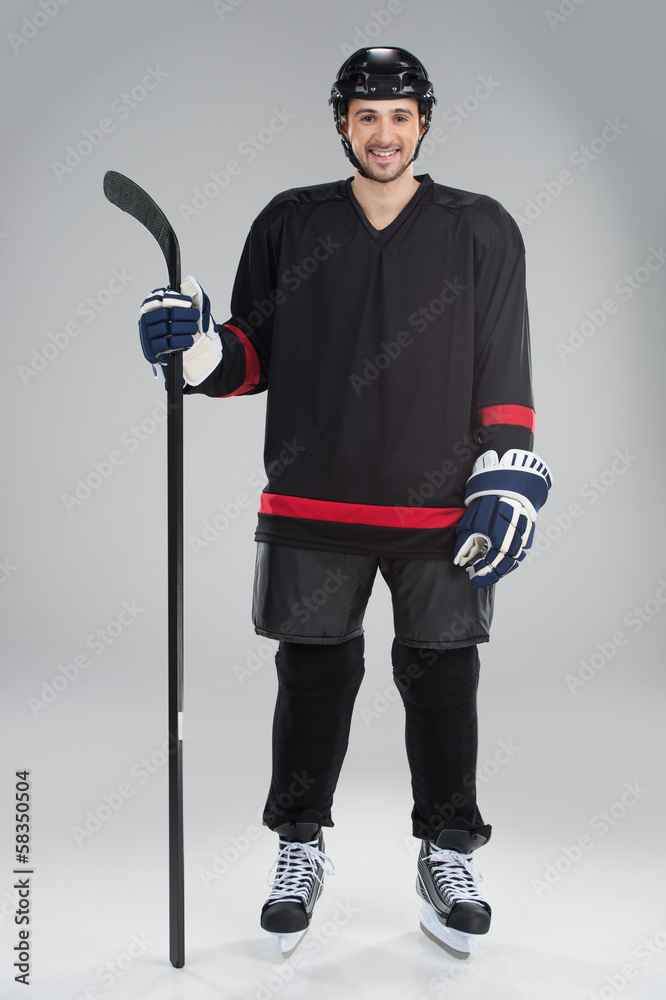 Fototapeta premium Attractive hockey player in uniform.