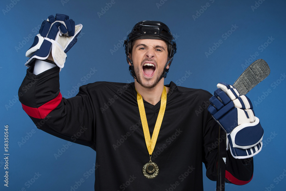 Naklejka premium Hockey player is celebrating his victory with happy emotion.