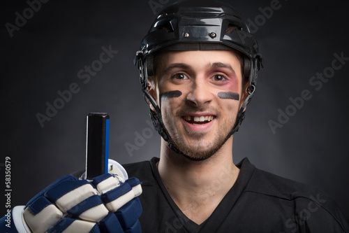 Funny hockey player smiling with one tooth missing.