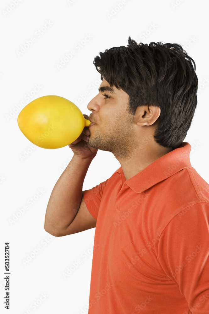 Man blowing up a balloon Man blowing up a balloon
