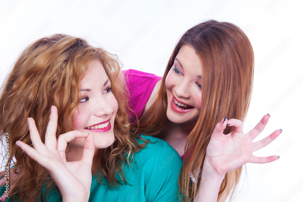 Young lighthearted girls shows Okay gesture Young lighthearted girls shows Okay gesture