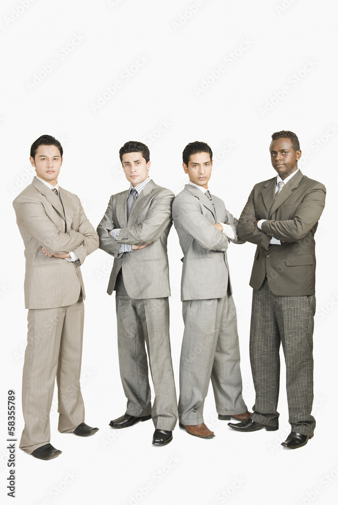 Portrait of four businessmen standing with arms crossed Portrait of four businessmen standing with arms crossed