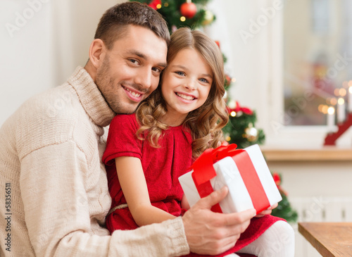 Wallpaper Mural smiling father and daughter holding gift box Torontodigital.ca
