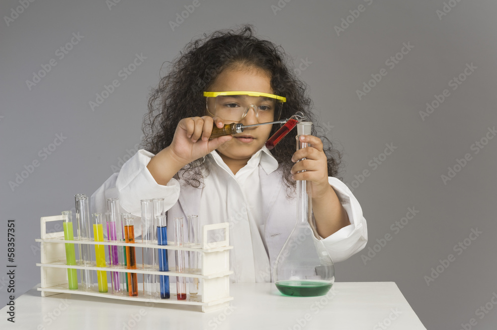 Girl dressed as scientist researching in the laboratory Girl dressed as scientist researching in the laboratory