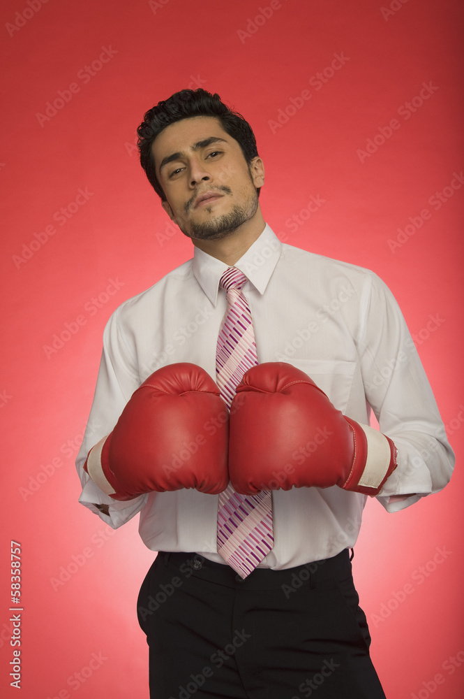 Portrait of a businessman wearing boxing gloves Portrait of a businessman wearing boxing gloves