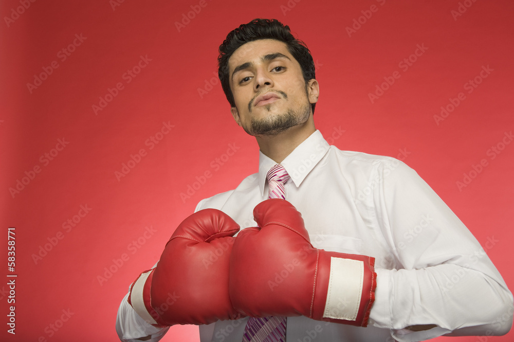 Portrait of a businessman wearing boxing gloves Portrait of a businessman wearing boxing gloves
