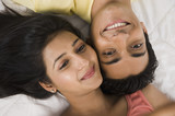 Close-up of a couple lying on the bed and smiling