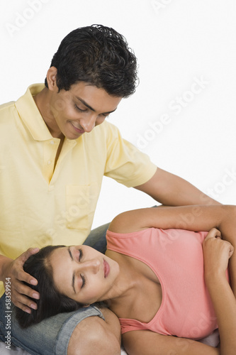 Woman sleeping on the lap of a man