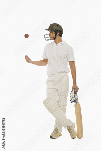 Картината върху платно Cricket batsman tossing a cricket ball