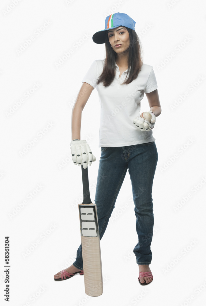 Portrait of a female cricket fan holding a bat and a ball Portrait of a female cricket fan holding a bat and a ball