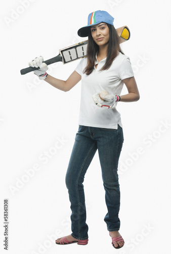 Portrait of a female cricket fan holding a bat and a ball © imagedb.com