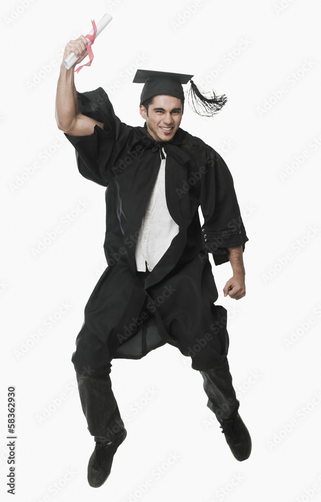 Man in a graduation gown holding a diploma and jumping Man in a graduation gown holding a diploma and jumping
